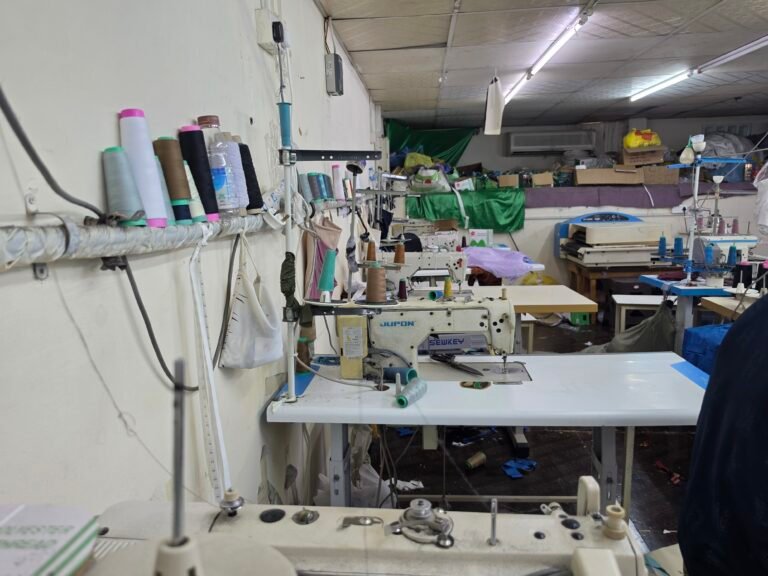 Industrial sewing machines on the Al Husn Garments production line